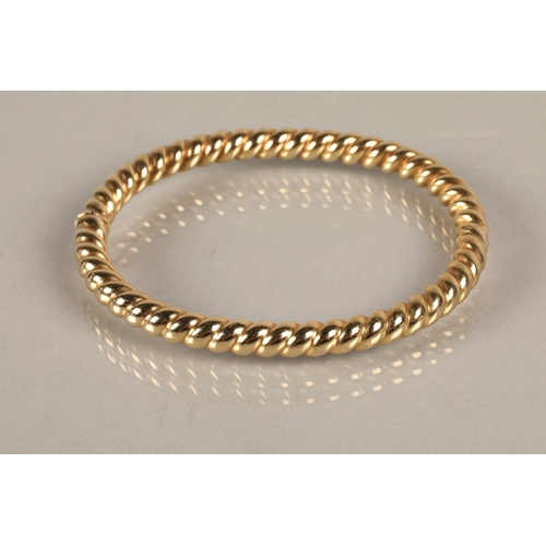 62 - 9ct gold twist bangle, 14.3g