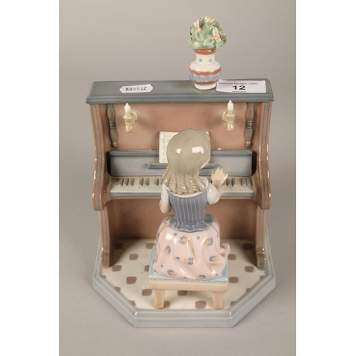 12 - Lladro figure, girl at a piano, 21cm high