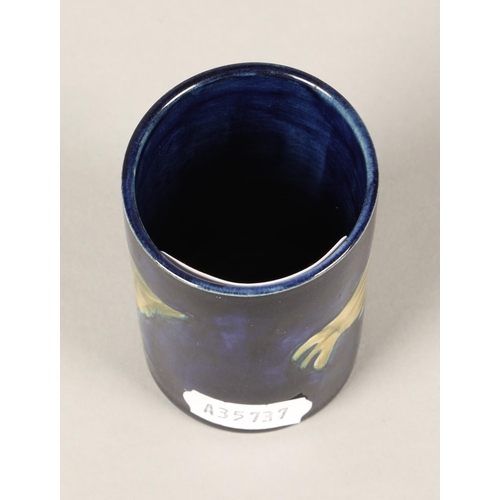 26 - Moorcroft small cylindrical vase, the blue ground decorated with poppies 7cm, paper label to base an... 