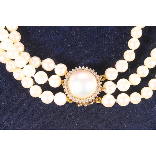 127 - Cultured pearl and diamond three row necklace and earrings suite, the pearls strung to an 18ct gold ... 