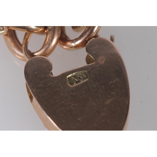 142 - 9ct yellow gold double curb link bracelet with padlock closure, the heart shaped padlock with rose a... 