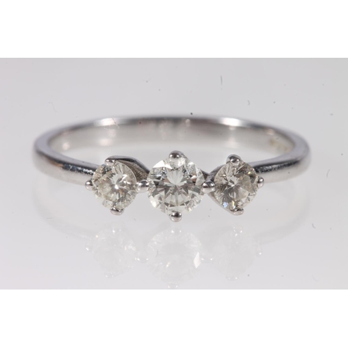 166 - 18ct white gold diamond three stone ring, the central 0.3ct diamond flanked by slightly smaller ston... 