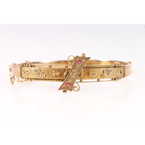 174 - Edwardian 9ct gold ruby and diamond set bangle, 7.2g gross.