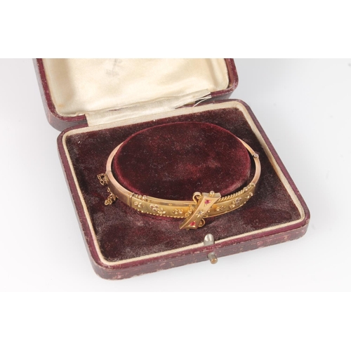 174 - Edwardian 9ct gold ruby and diamond set bangle, 7.2g gross.