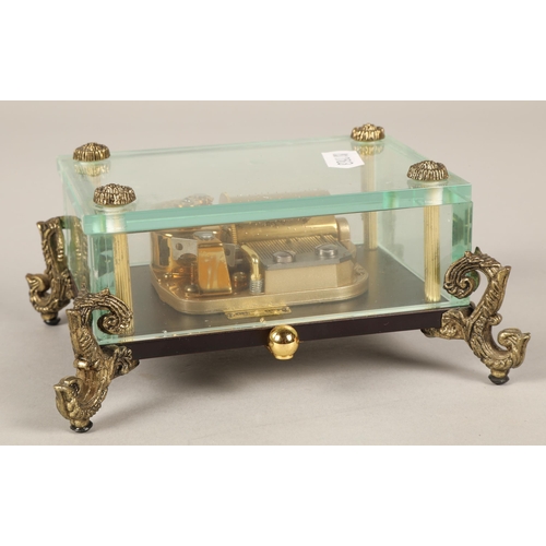 242 - Rhymer musical casket on scroll supports, in fitted box.