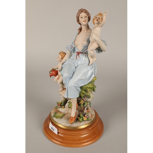 268 - Capodimonte figure of a female by a mile post and another similar of a mother and two putti (2)