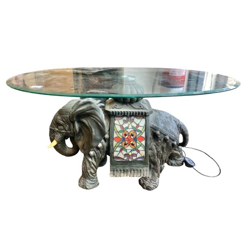 503 - Oval glass top table on elephant base, base is also a lamp but plug needs rewiring