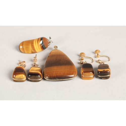 137 - Tigers Eye jewellery to include two pendants and two pairs of earrings (one pair screw-on), earrings... 