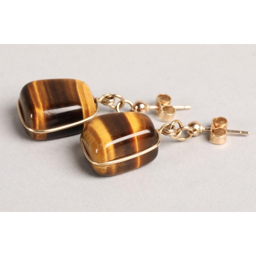 137 - Tigers Eye jewellery to include two pendants and two pairs of earrings (one pair screw-on), earrings... 