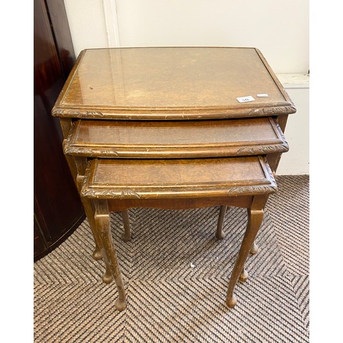 546 - Nest of three glass topped walnut side tables 