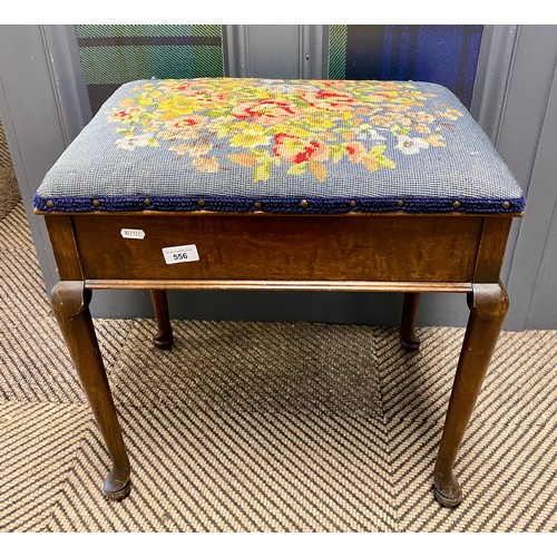 556 - Mahogany piano stool in floral upholstery, raised on cabriole legs 