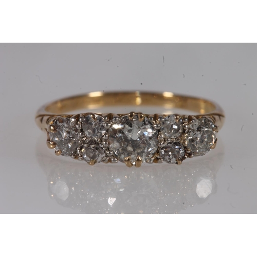 130 - Edwardian 18ct gold and seven diamond ring, the seven round cut graduating stones approximately 0.9 ... 