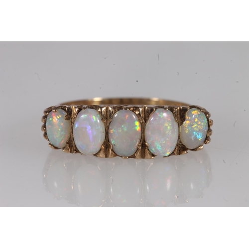 133 - 9ct gold and white opal five stone ring, the graduating oval cabochon opals on a scrolled mount, ree... 