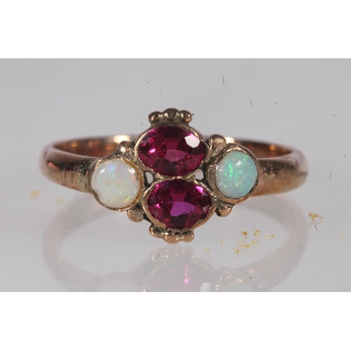 191 - Early 20th century yellow metal pink stone and opal ring, the oval cut pink stones flanked by caboch... 