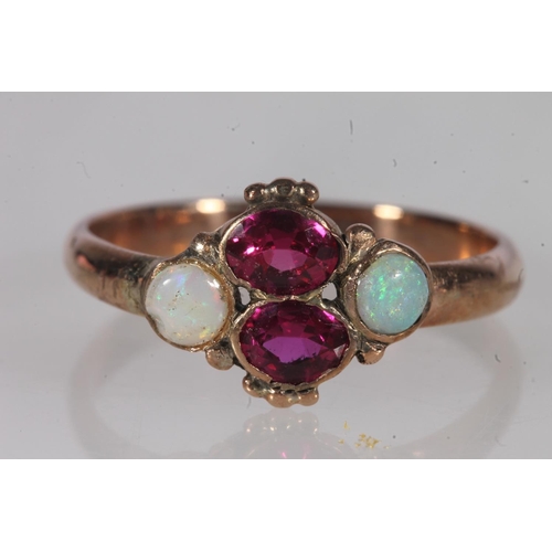 191 - Early 20th century yellow metal pink stone and opal ring, the oval cut pink stones flanked by caboch... 