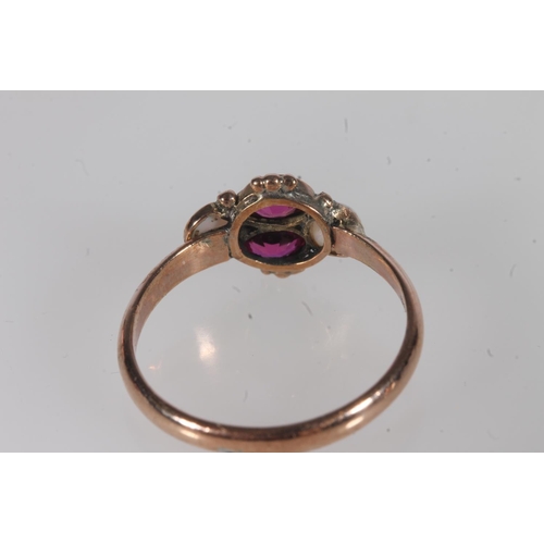 191 - Early 20th century yellow metal pink stone and opal ring, the oval cut pink stones flanked by caboch... 