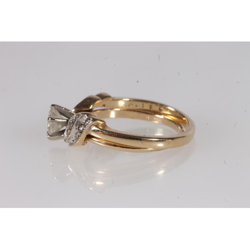 194 - 14ct gold and diamond solitaire puzzle ring, the interlocking bands set in wing form with small roun... 