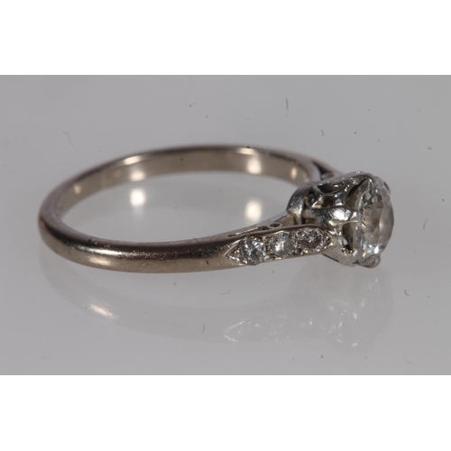 198 - 18ct gold and diamond solitaire ring, the round cut brilliant prong set on a platinum cathedral moun... 