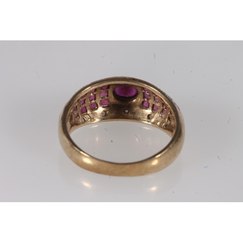 200 - 9ct gold ruby and diamond ring, the bezel set central oval ruby flanked by interspersed ruby bands a... 