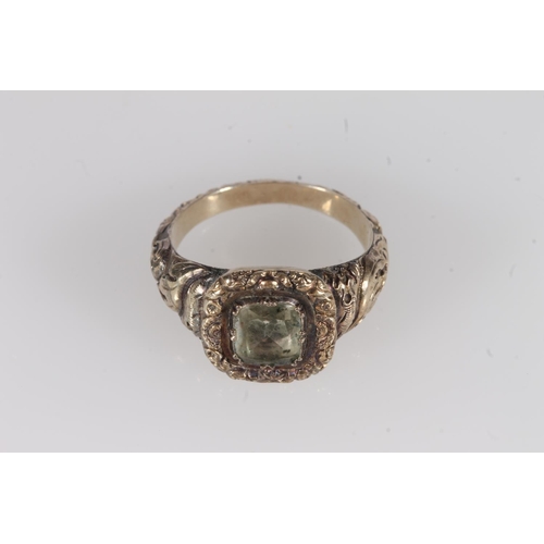 203 - Victorian yellow metal ring, the clear foil backed stone on a fancy engraved mount and conforming ta... 