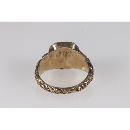 203 - Victorian yellow metal ring, the clear foil backed stone on a fancy engraved mount and conforming ta... 