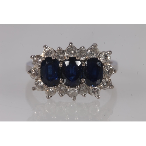 204 - 18ct white gold, sapphire and diamond cluster ring, the three oval cut sapphires framed on a bed of ... 