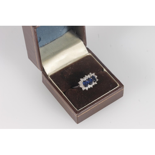 204 - 18ct white gold, sapphire and diamond cluster ring, the three oval cut sapphires framed on a bed of ... 