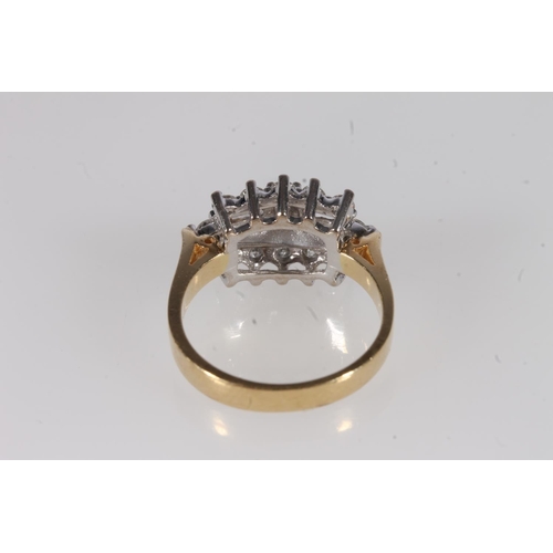 209 - 18ct gold and diamond cluster ring, the central baguette cut diamonds flanked by twelve individual r... 