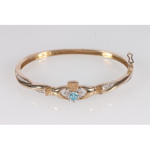 221 - 9ct gold Claddagh type bangle, set with a heart shaped aquamarine and small white stones, 16.3g, int... 