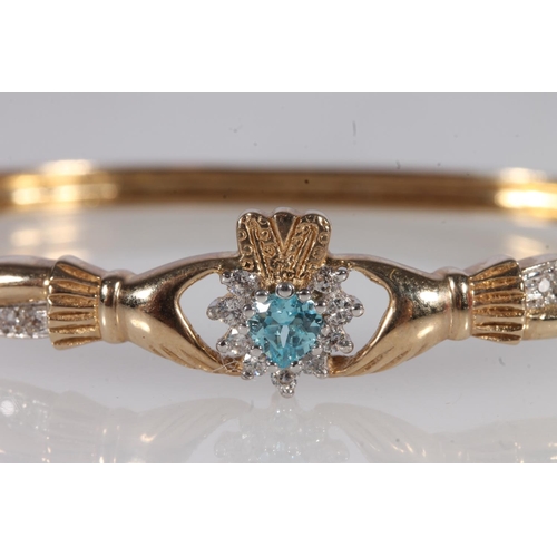 221 - 9ct gold Claddagh type bangle, set with a heart shaped aquamarine and small white stones, 16.3g, int... 