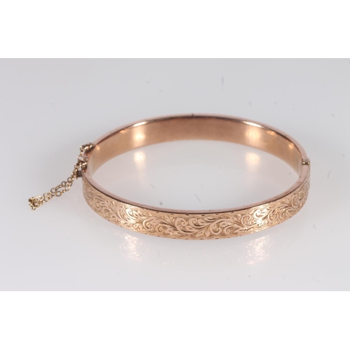 222 - Early 20th century 9ct rose gold half engraved bangle, 9.8g, internal width 6.4cm, in original box.