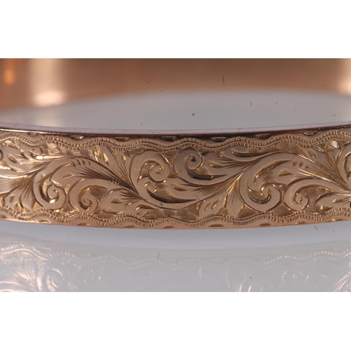 222 - Early 20th century 9ct rose gold half engraved bangle, 9.8g, internal width 6.4cm, in original box.