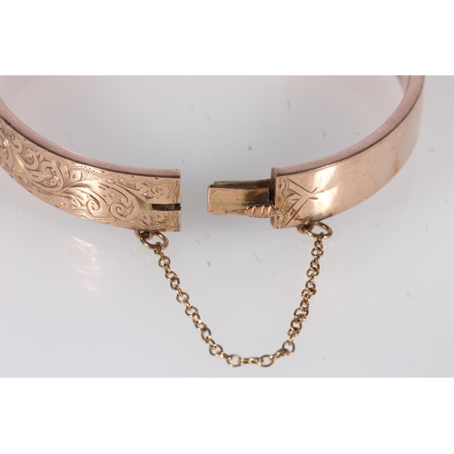 222 - Early 20th century 9ct rose gold half engraved bangle, 9.8g, internal width 6.4cm, in original box.