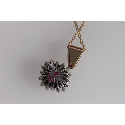 228 - Ruby and diamond cluster pendant, the oval cut ruby within a halo of round and trapezoid tapered dia... 