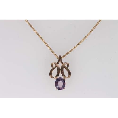 237 - Amethyst and yellow metal pendant, the openwork scroll frame above an oval amethyst, on fine 9ct gol... 