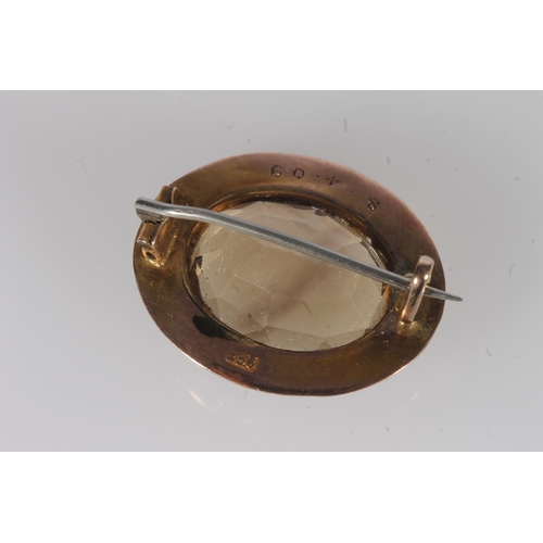 239 - Victorian 9ct gold and citrine brooch, the oval cut citrine framed within an engraved gold mount, 2.... 