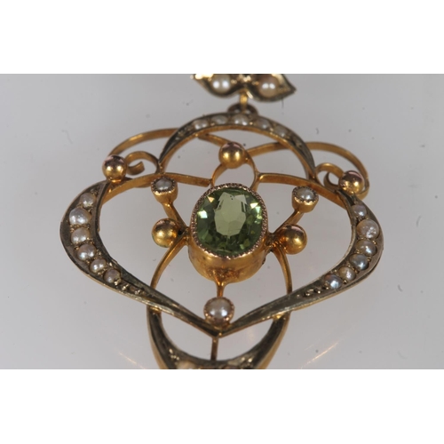 242 - Edwardian 9ct gold peridot and seed pearl lavaliere pendant, the oval peridot within an openwork fra... 