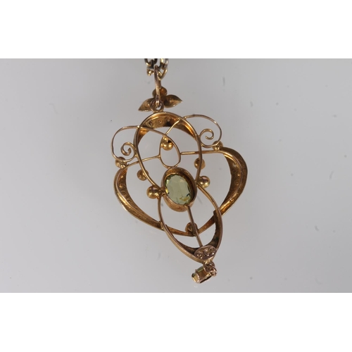 242 - Edwardian 9ct gold peridot and seed pearl lavaliere pendant, the oval peridot within an openwork fra... 