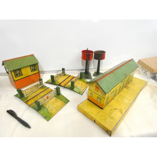 373 - Large box of tinplate 0-gauge buildings to include stations No2, No3, goods shed etc.