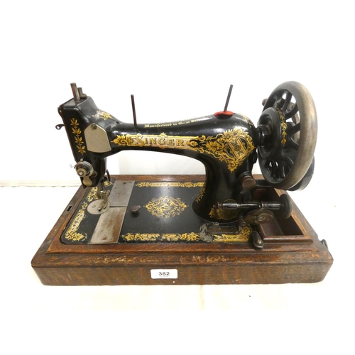 382 - Oak cased Singer sewing machine.