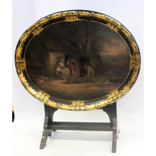 619 - Victorian oval papier mache tray table, the table top painted with a rustic cottage family scene wit... 