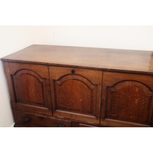 634 - Oak Mule chest, the three arched panels opening to reveal shelved compartment, above two drawers on ... 