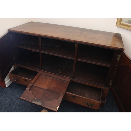 634 - Oak Mule chest, the three arched panels opening to reveal shelved compartment, above two drawers on ... 