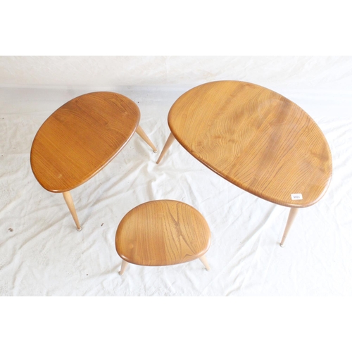 622 - Nest of three 1960s Ercol elm and beech pebble tables.