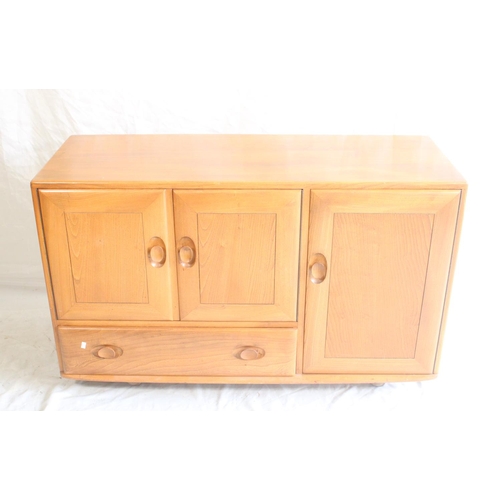 626 - Ercol Windsor model 468 elm sideboard, having a twin door cupboard alongside a single door cupboard ... 