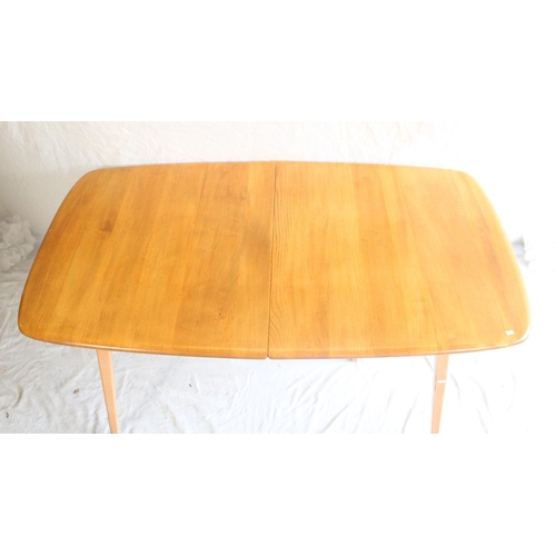 627 - Ercol light elm Grand Windsor extending dining table, with hinged undertier extension leaf, L152cm u... 