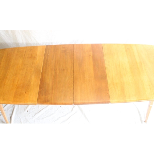 627 - Ercol light elm Grand Windsor extending dining table, with hinged undertier extension leaf, L152cm u... 