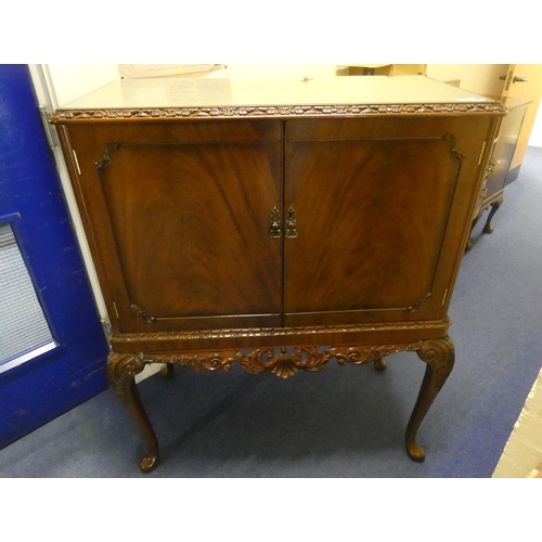 452 - Reproduction mahogany drinks cabinet with with carved cresting.