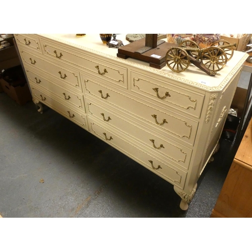 475 - Large cream chest of nine drawers.