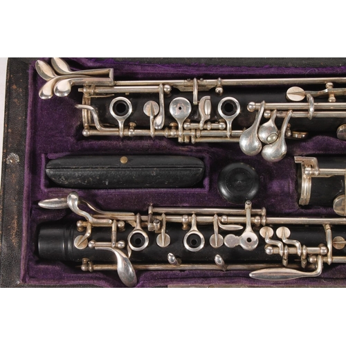 404 - Oboe by F. Lorée of Paris, with silver plated keys and stamped F. Lorée, Paris no. FF 25, purple vel... 